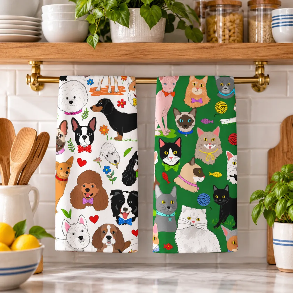 Dog and cat tea towels hanging from a brass rail in a bright kitchen